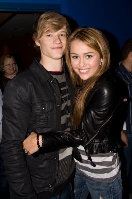 89803_miley_cyrus_and_lucas_till_share_a_moment_on_the_access_stage.jpg